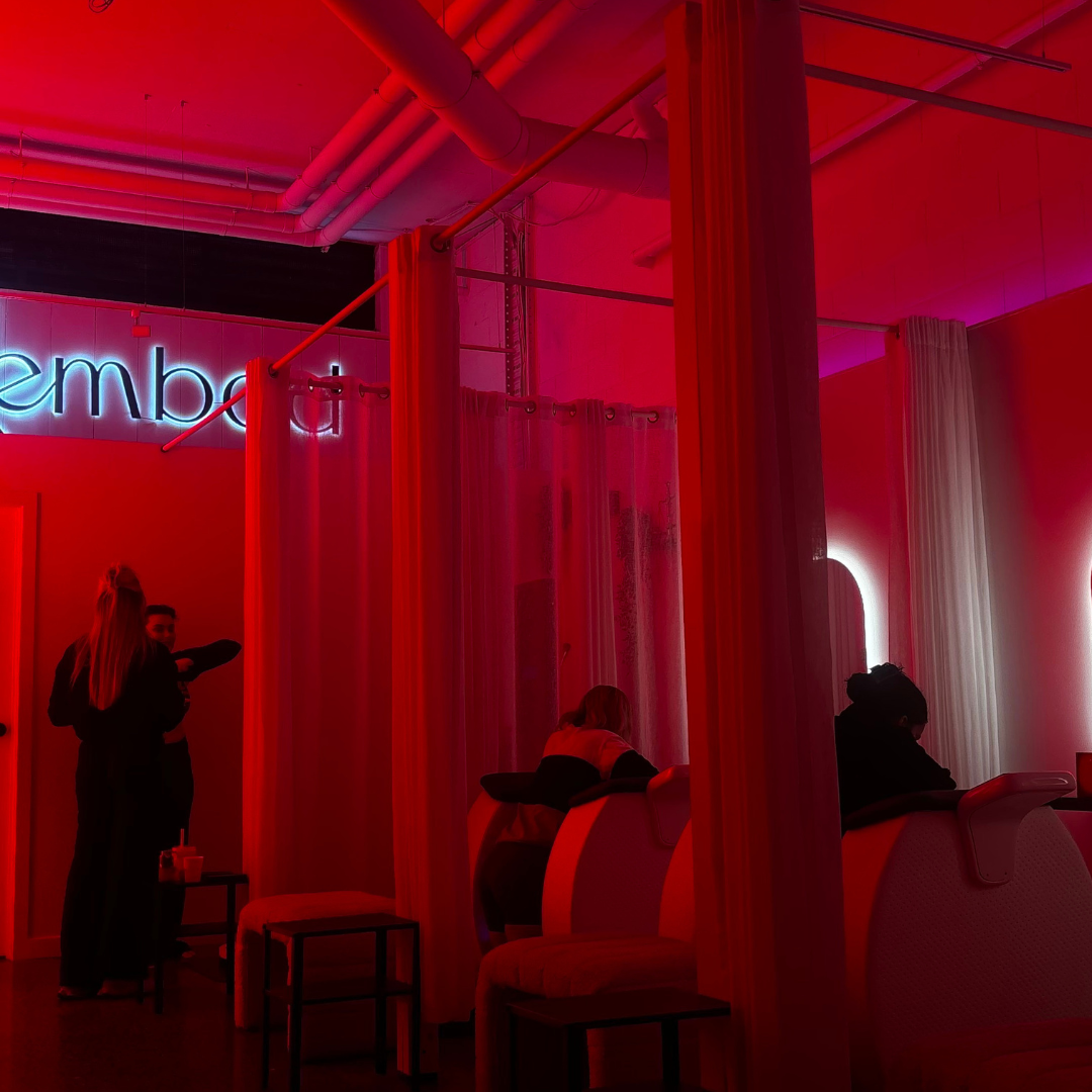 Guests at a red-lit Embod studio experience