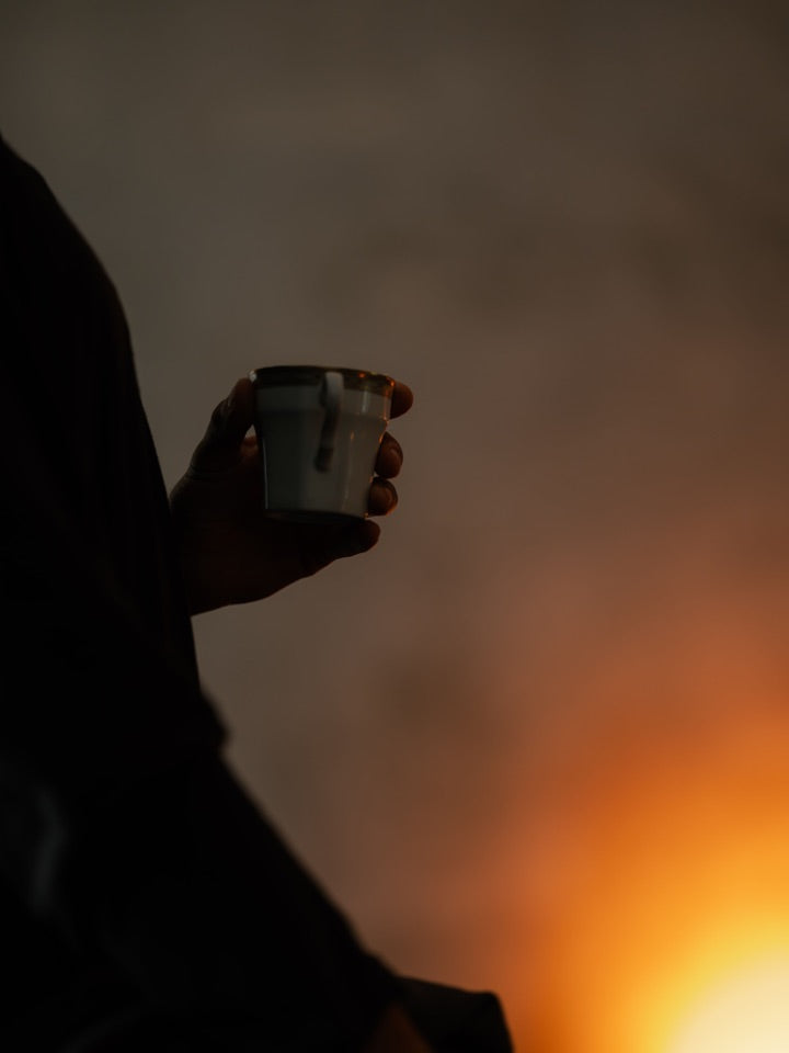 A hand in warm candlelight